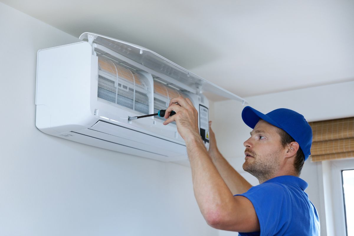 AC repair technician working in GTA home